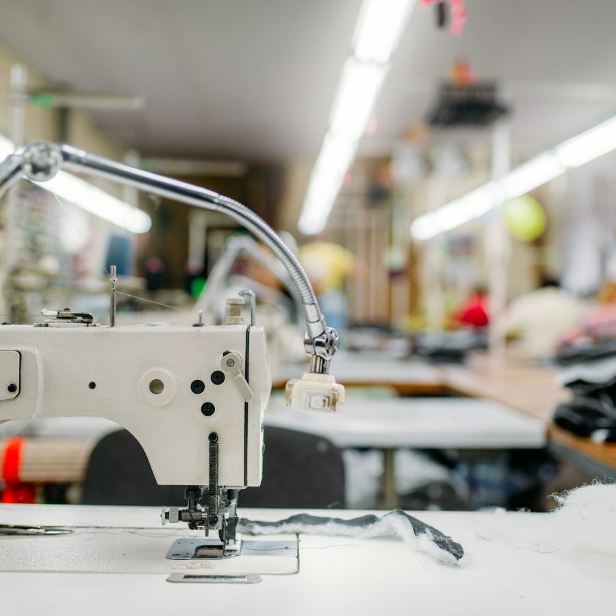 Sewing machine on clothing fabric, nobody. Dressmaking industry, Equipment on dress factory, professional tailoring S